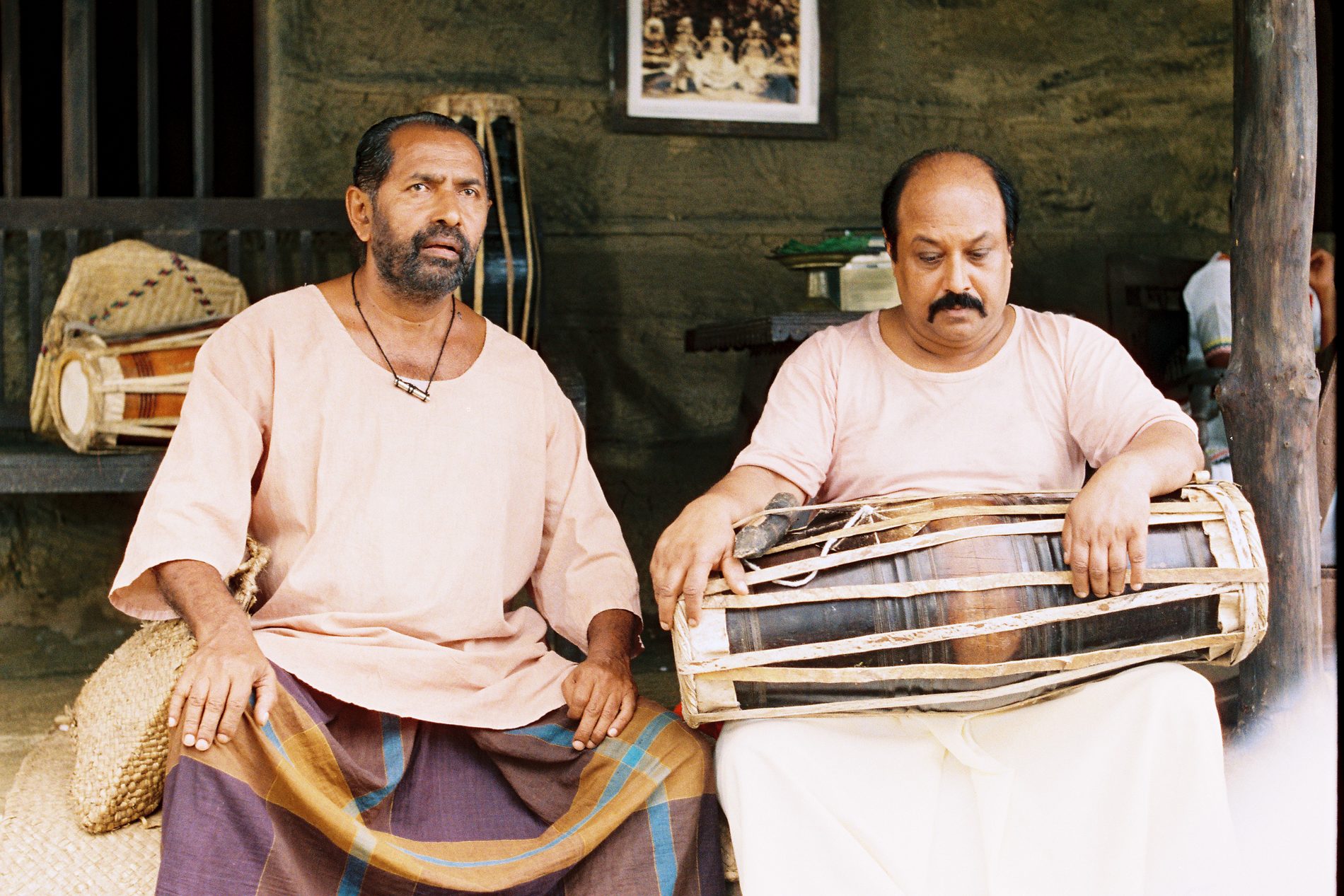 Manoratne seated beside a second drummer.